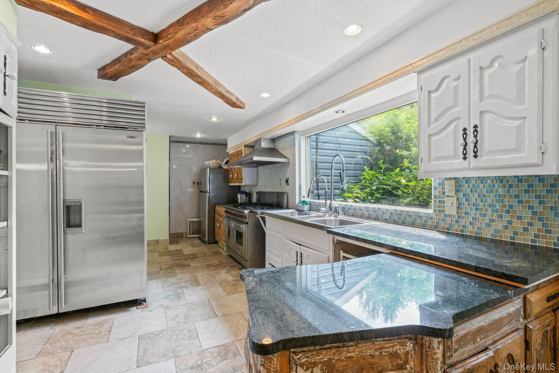 13 Whitney Circle Glen Cove, NY 11542 - Photo 16 of 44 Kitchen with premium appliances, decorative backsplash, dark stone countertops, recessed lighting, and white cabinets