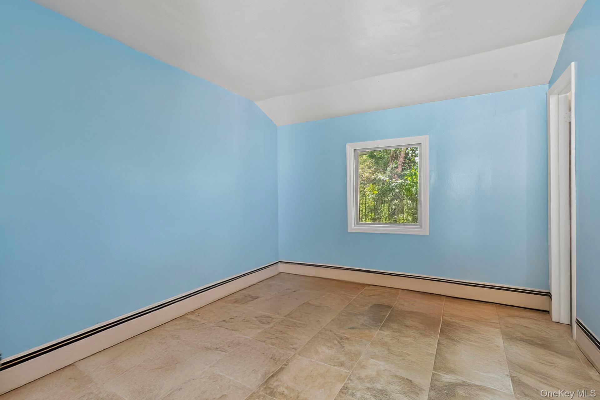 13 Whitney Circle Glen Cove, NY 11542 - Photo 19 of 44 Unfurnished room featuring a baseboard heating unit and vaulted ceiling