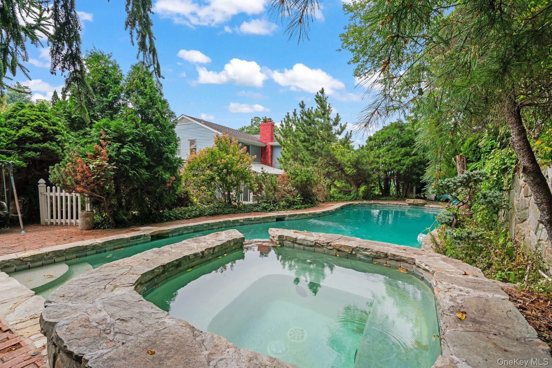 13 Whitney Circle Glen Cove, NY 11542 - Photo 29 of 44 View of pool with a patio area and a pool with connected hot tub