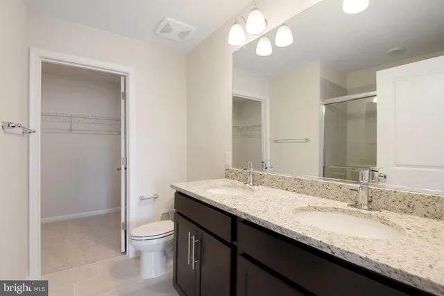 a bathroom with a glass shower door