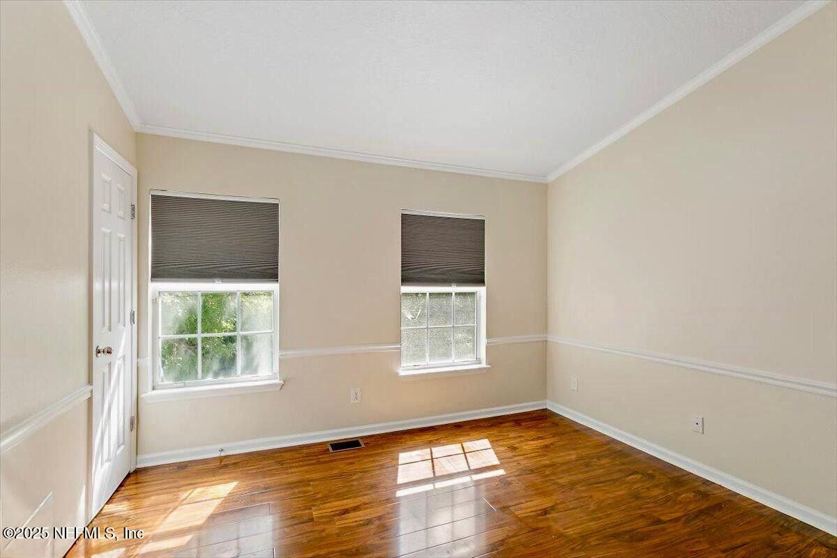 3502 Summerlin Lane North Jacksonville, FL 32224 - Photo 17 of 26 a view of an empty room with wooden floor and a window