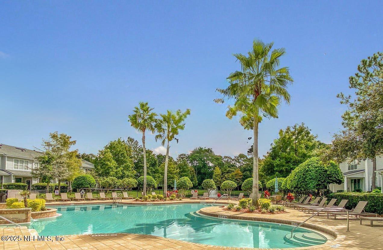 3502 Summerlin Lane North Jacksonville, FL 32224 - Photo 20 of 26 a view of a swimming pool and trees in the background