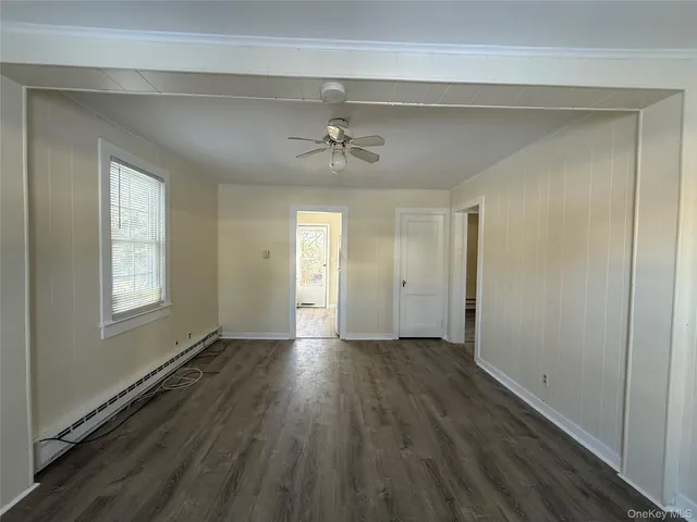 wooden floor in an empty room with a window