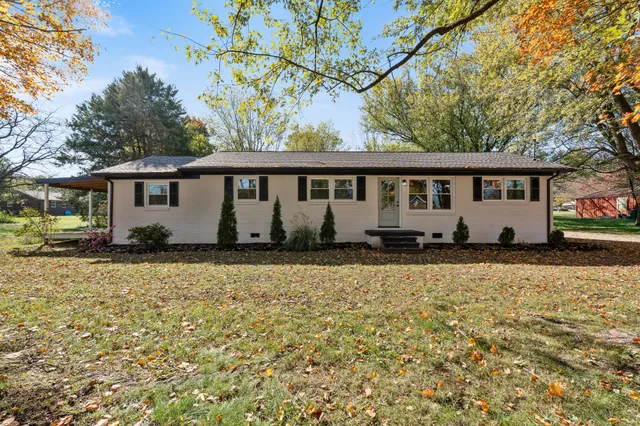 a view of house with yard