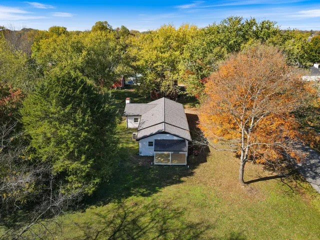an aerial view of a houses with a lake view