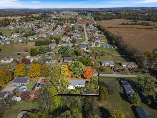 an aerial view of a house with a yard