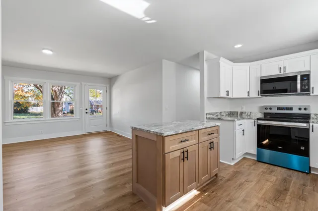 a kitchen with a stove top oven and cabinets