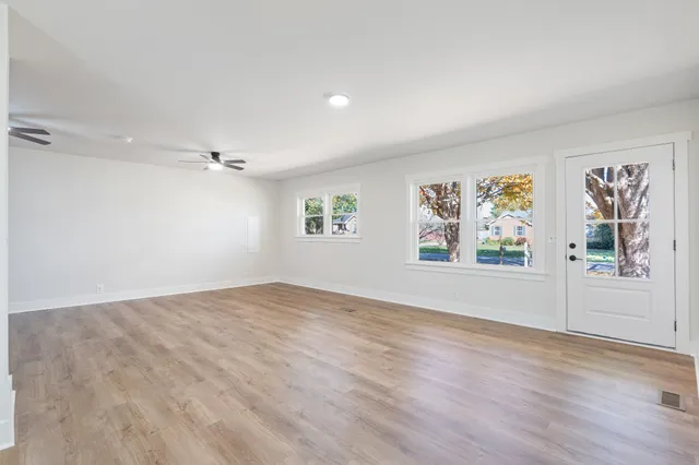 wooden floor in an empty room with a window