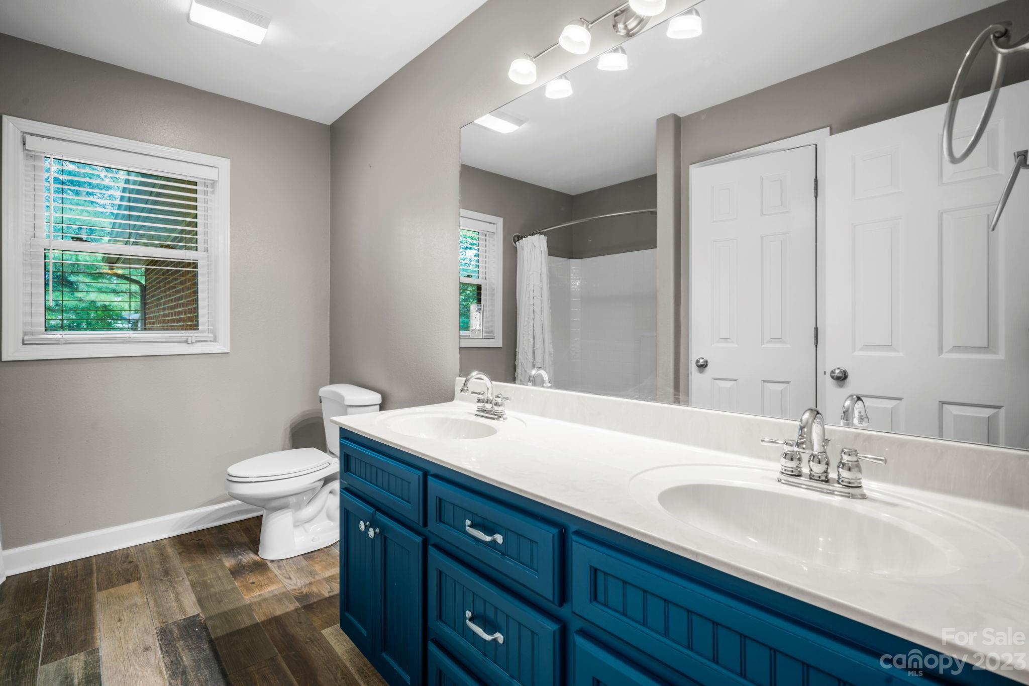 309 Sheldon Street Hudson, NC 28638 - Photo 11 of 40 a bathroom with a double vanity sink toilet and a mirror