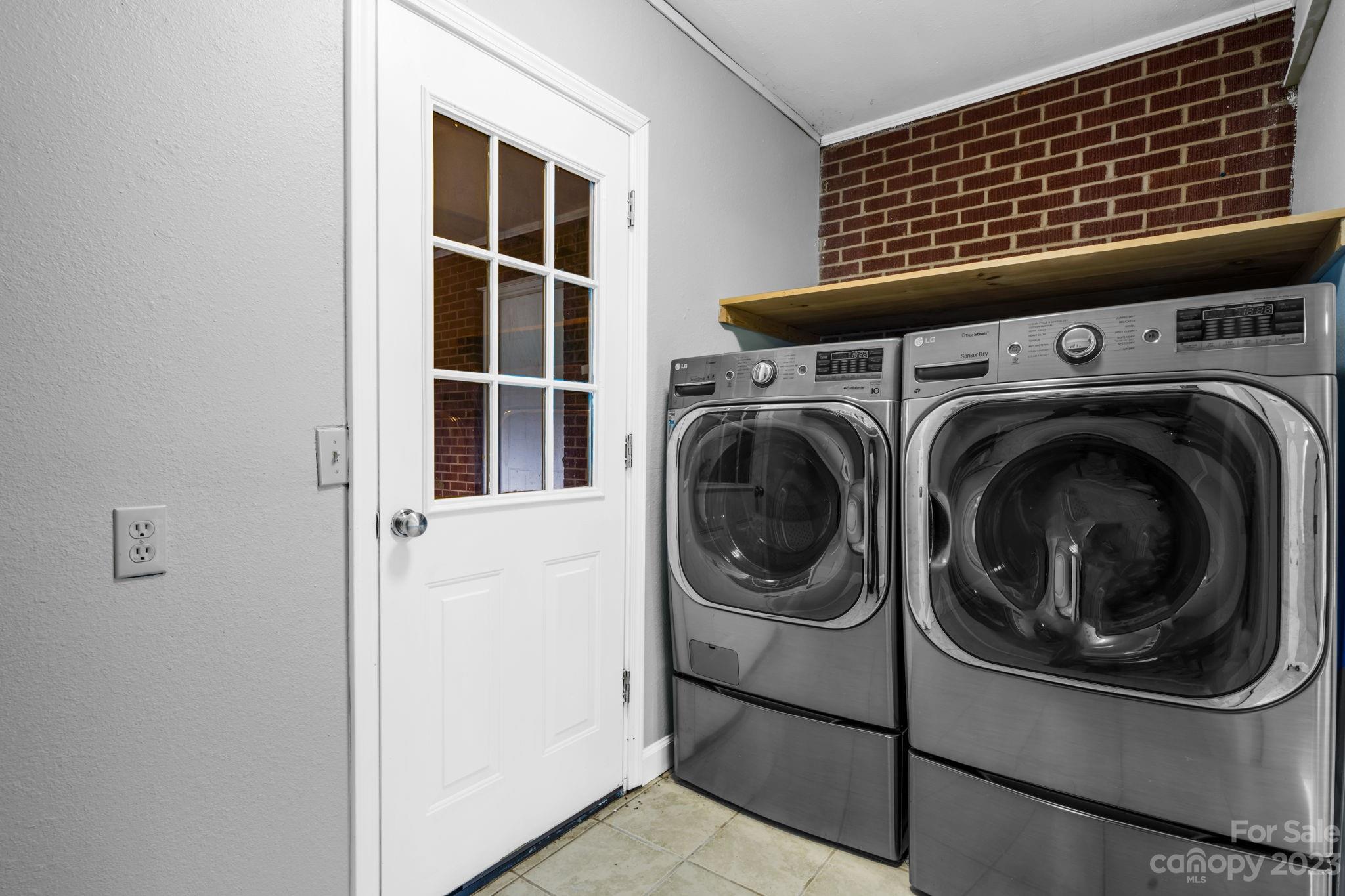 309 Sheldon Street Hudson, NC 28638 - Photo 22 of 40 a view of storage and utility room with washer and dryer