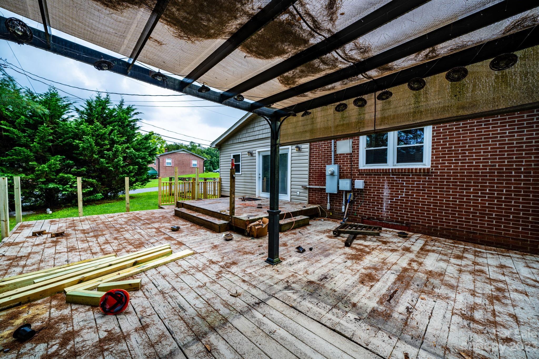 309 Sheldon Street Hudson, NC 28638 - Photo 33 of 40 a roof deck with table and chairs and potted plants