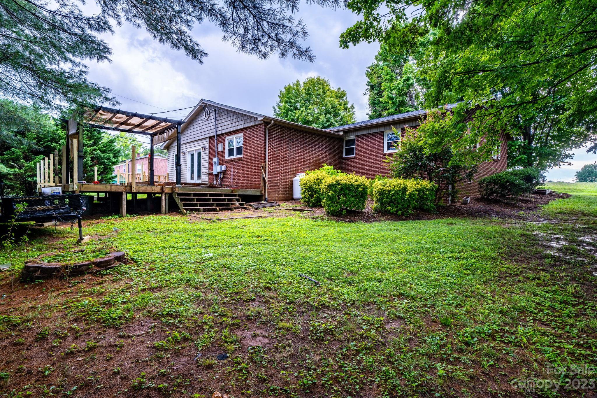309 Sheldon Street Hudson, NC 28638 - Photo 34 of 40 a view of a house with a backyard