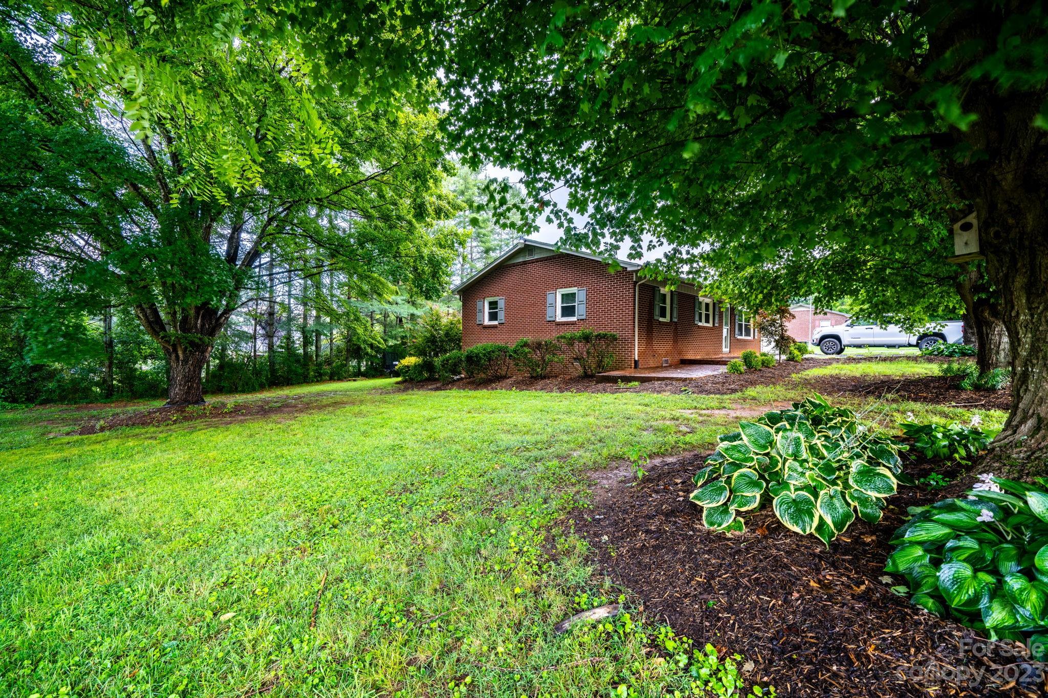 309 Sheldon Street Hudson, NC 28638 - Photo 38 of 40 a view of a yard with a house in the background