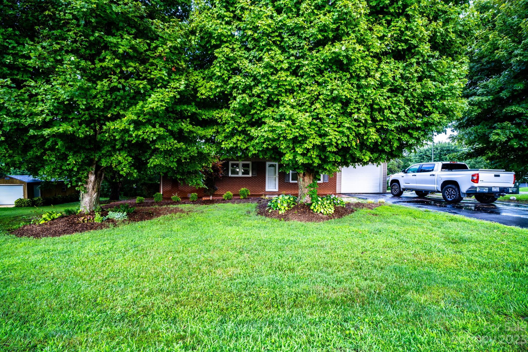 309 Sheldon Street Hudson, NC 28638 - Photo 39 of 40 a front view of a house with garden