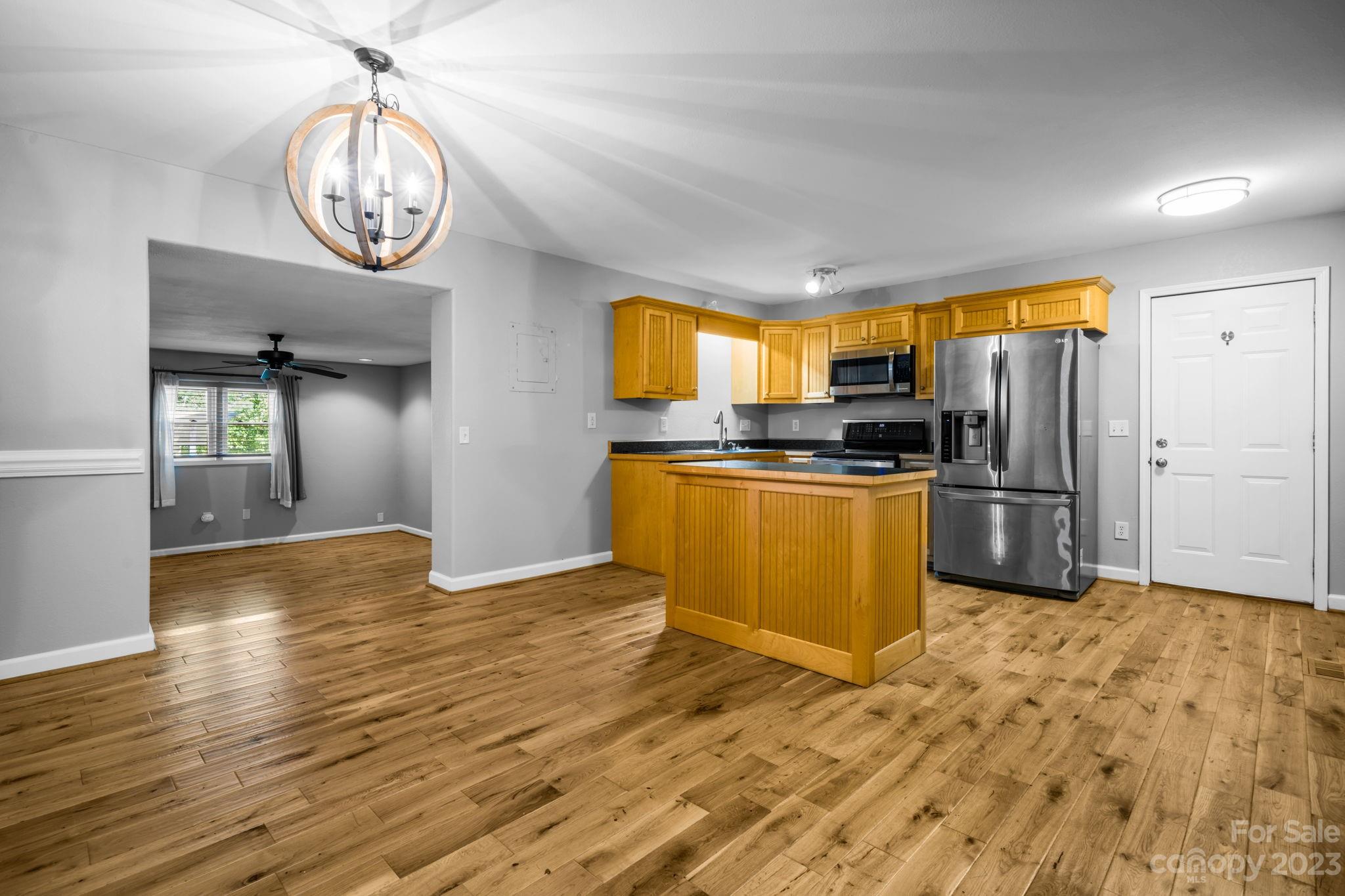309 Sheldon Street Hudson, NC 28638 - Photo 5 of 40 a view of a kitchen with a sink a refrigerator and a stove top oven