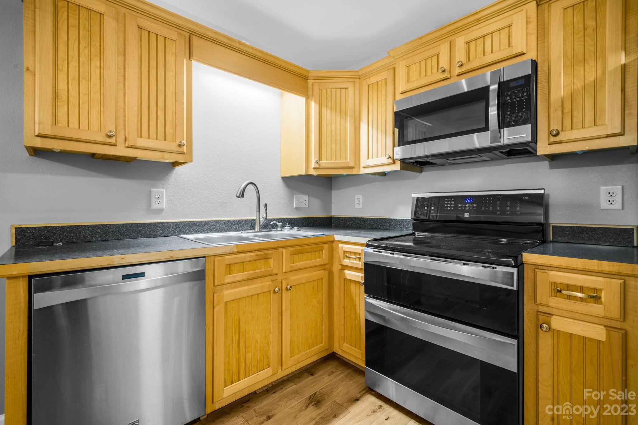 309 Sheldon Street Hudson, NC 28638 - Photo 6 of 40 a kitchen with stainless steel appliances granite countertop a stove microwave and sink