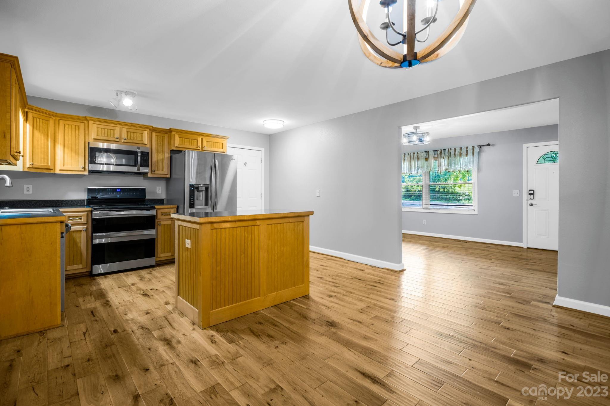 309 Sheldon Street Hudson, NC 28638 - Photo 7 of 40 a view of kitchen with furniture wooden floor and window