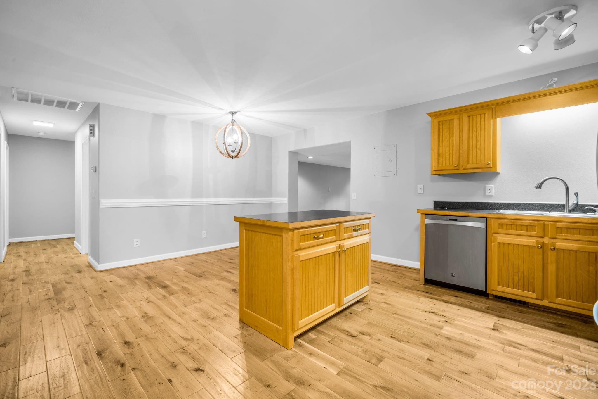 309 Sheldon Street Hudson, NC 28638 - Photo 8 of 40 a kitchen with granite countertop a sink cabinets and stainless steel appliances