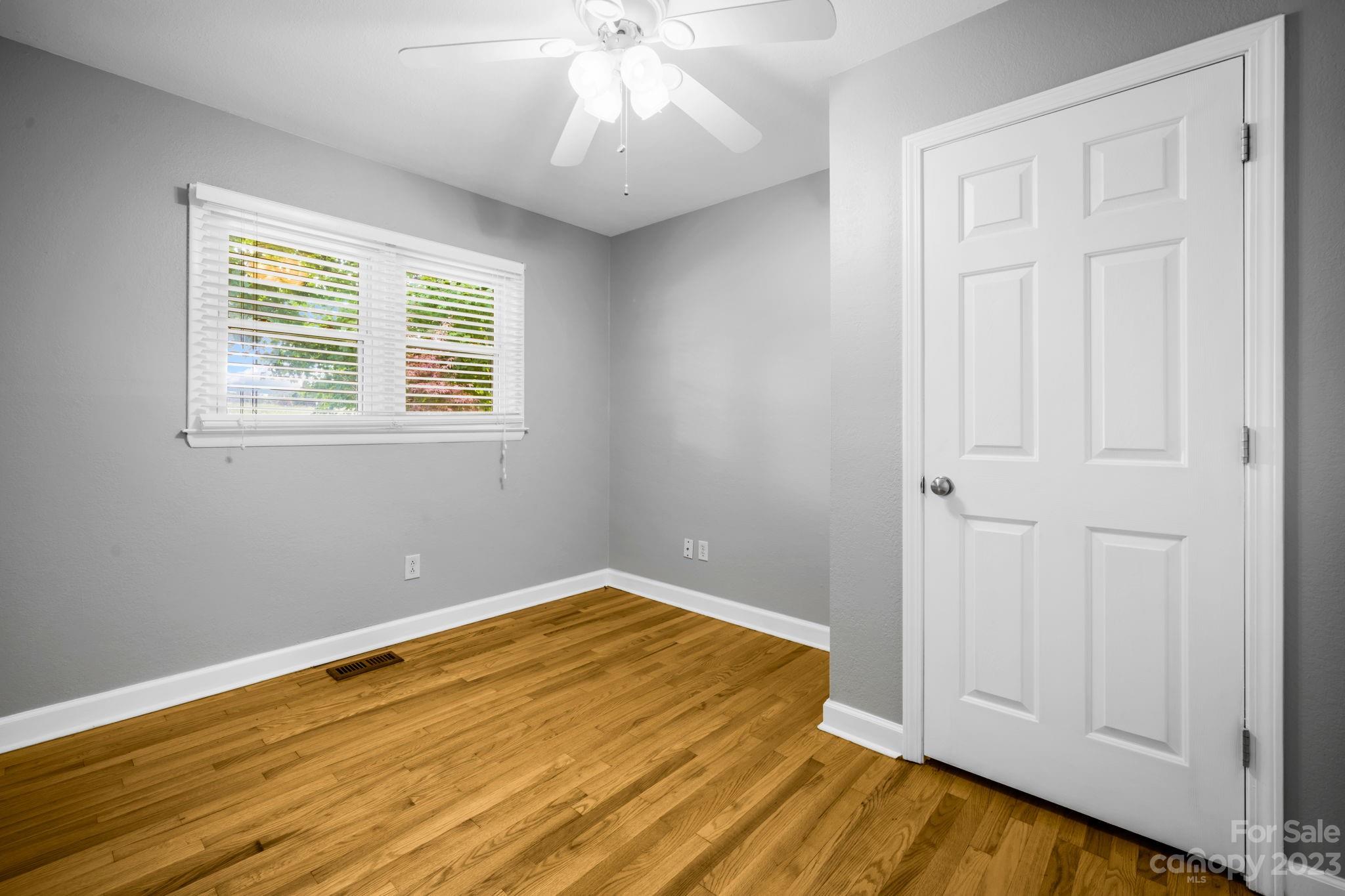 309 Sheldon Street Hudson, NC 28638 - Photo 10 of 40 a view of empty room with wooden floor and fan