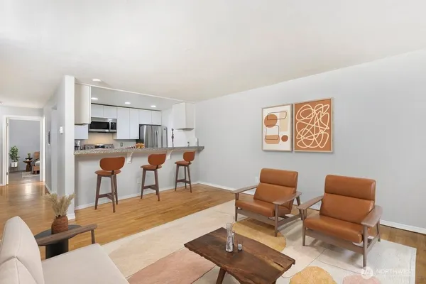 a living room with furniture and a kitchen view