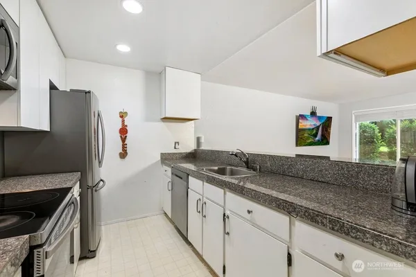 a kitchen with a sink stove and refrigerator