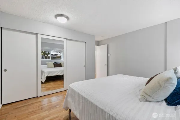 a bedroom with a bed and a view of closet
