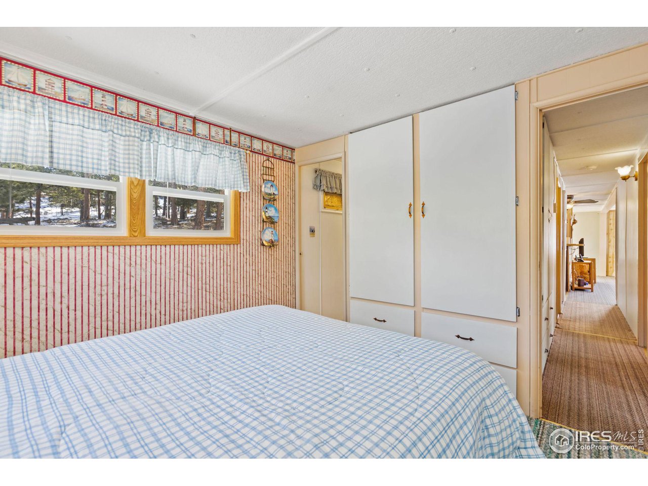 36 Comanche Circle Red Feather Lakes, CO 80545 - Photo 11 of 40 a bedroom with a bed and a painting on the wall
