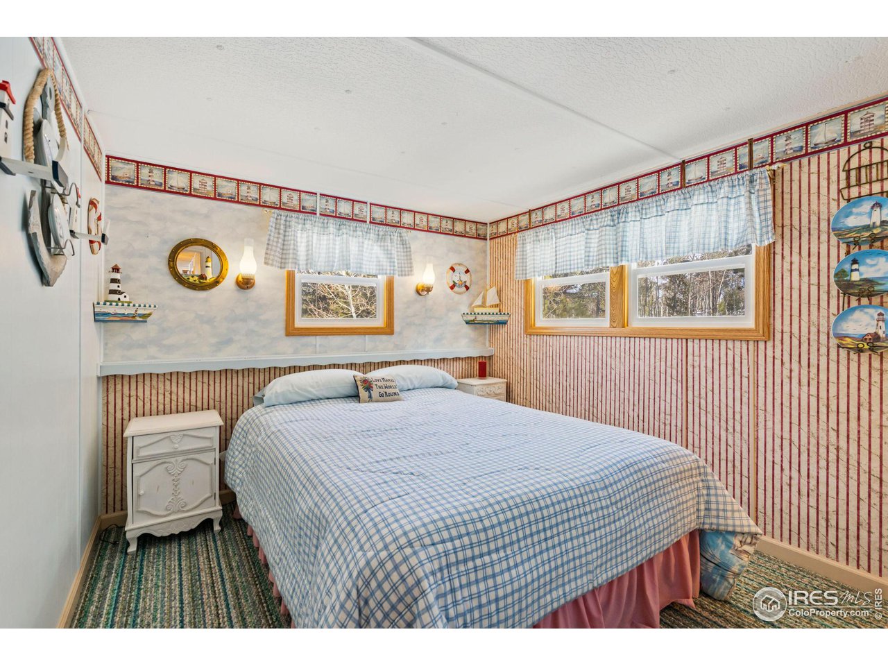 36 Comanche Circle Red Feather Lakes, CO 80545 - Photo 13 of 40 a bedroom with a bed and a painting on the wall