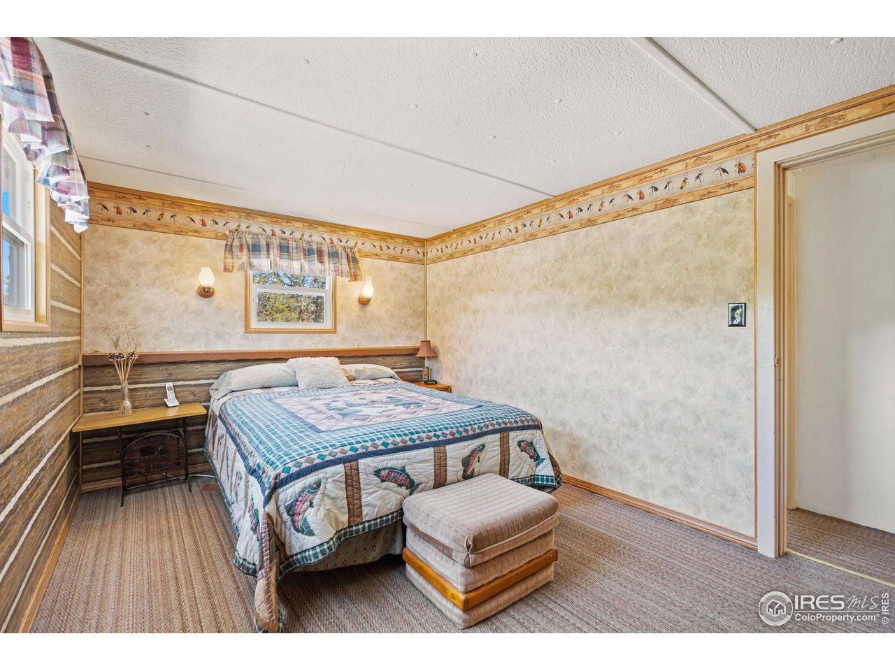 36 Comanche Circle Red Feather Lakes, CO 80545 - Photo 16 of 40 a bedroom with a bed and a window