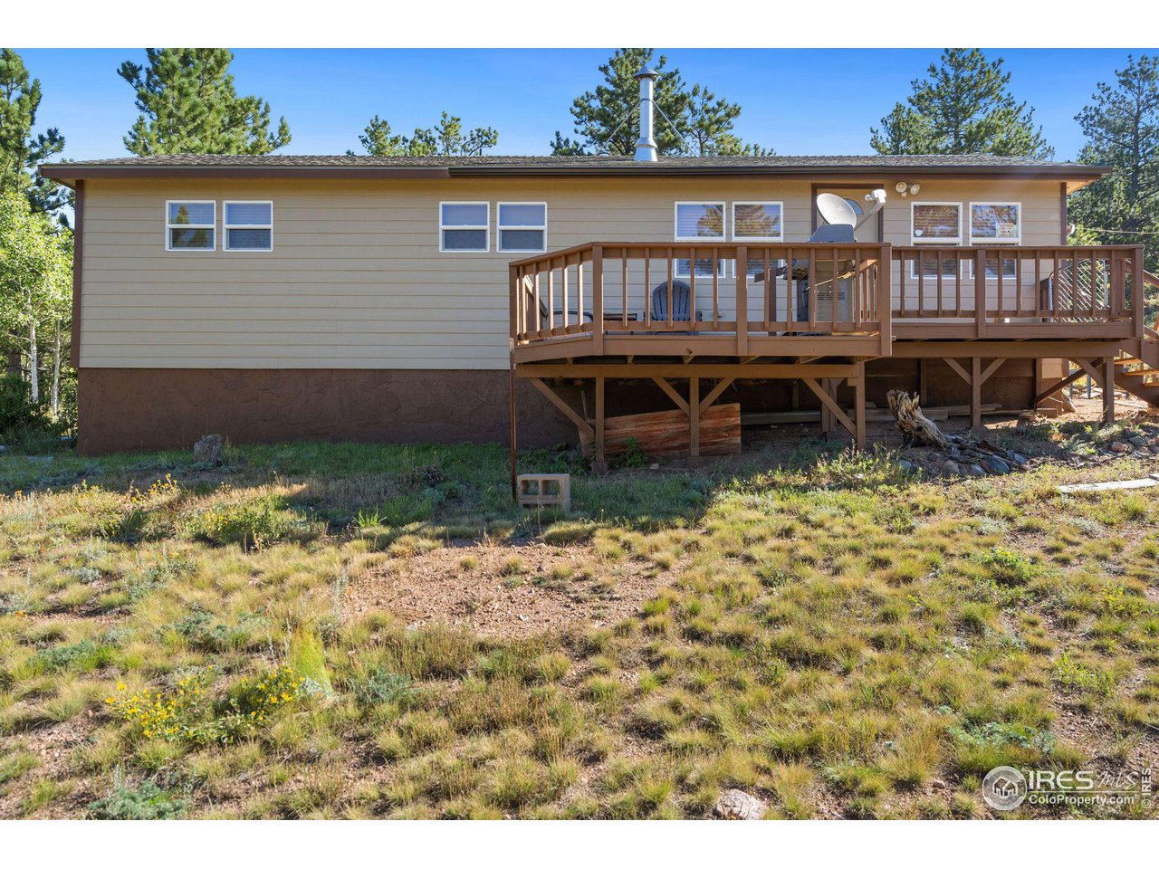 36 Comanche Circle Red Feather Lakes, CO 80545 - Photo 26 of 40 front view of a house with a yard