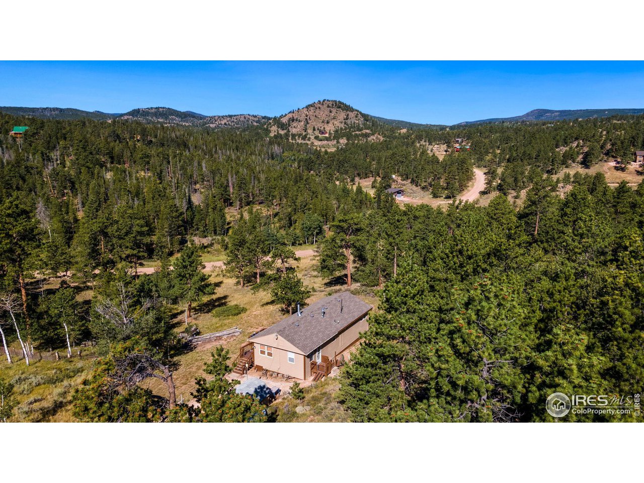 36 Comanche Circle Red Feather Lakes, CO 80545 - Photo 40 of 40 a view of a green field with mountains in the background