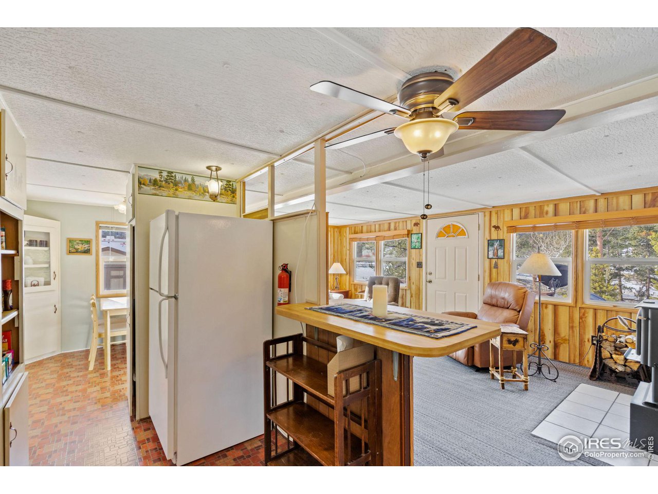 36 Comanche Circle Red Feather Lakes, CO 80545 - Photo 6 of 40 a room with stainless steel appliances kitchen island granite countertop furniture and a chandelier