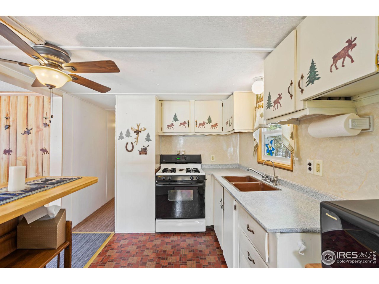 36 Comanche Circle Red Feather Lakes, CO 80545 - Photo 9 of 40 a kitchen with stainless steel appliances granite countertop a stove a sink and a refrigerator