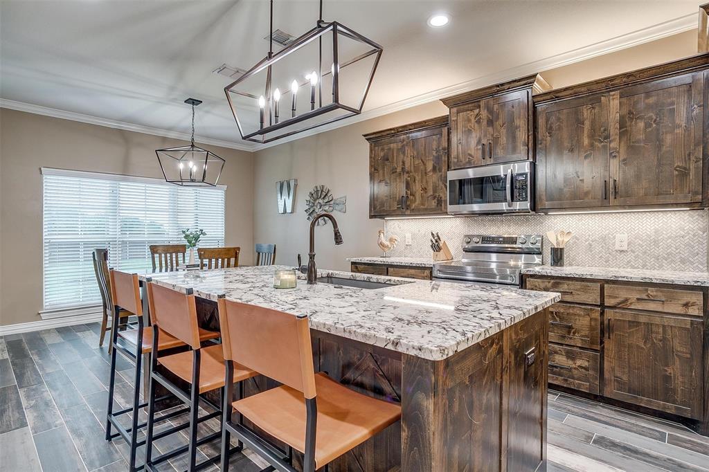 850 McClendon Walker Road Aledo, TX 76008 - Photo 13 of 38 a kitchen with a table chairs sink and cabinets