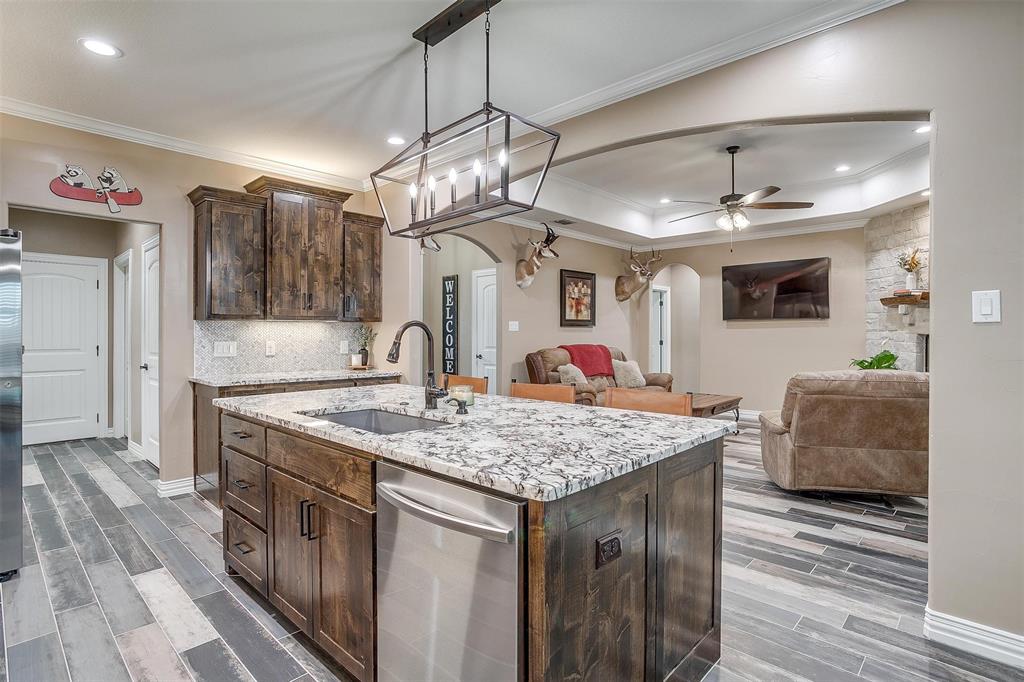 850 McClendon Walker Road Aledo, TX 76008 - Photo 16 of 38 a kitchen with stainless steel appliances granite countertop a kitchen island a stove and a wooden floors