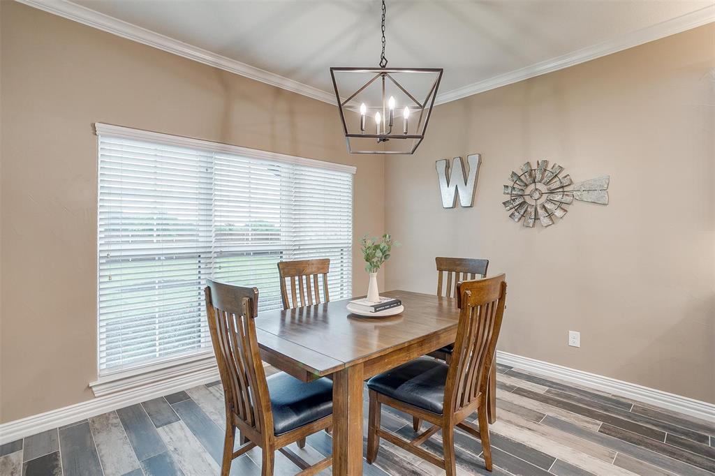 850 McClendon Walker Road Aledo, TX 76008 - Photo 17 of 38 a view of a dining room with furniture wooden floor and chandelier