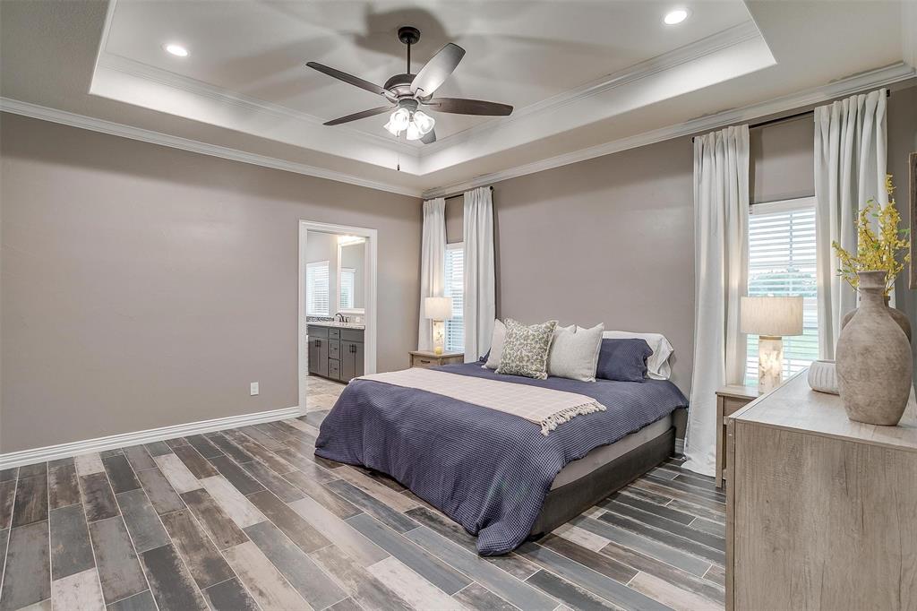 850 McClendon Walker Road Aledo, TX 76008 - Photo 19 of 38 a bedroom with a large bed and a chandelier