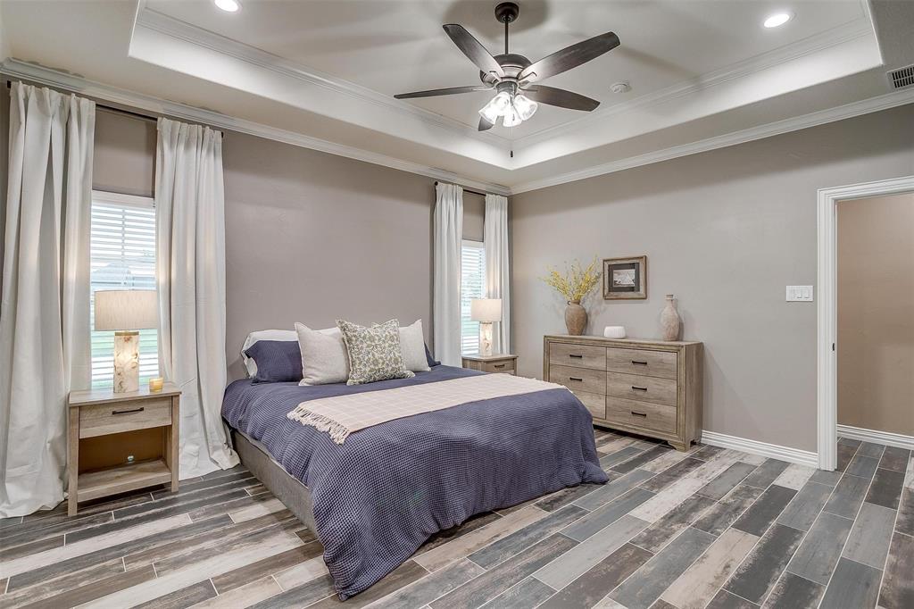 850 McClendon Walker Road Aledo, TX 76008 - Photo 20 of 38 a bedroom with a bed and a chandelier