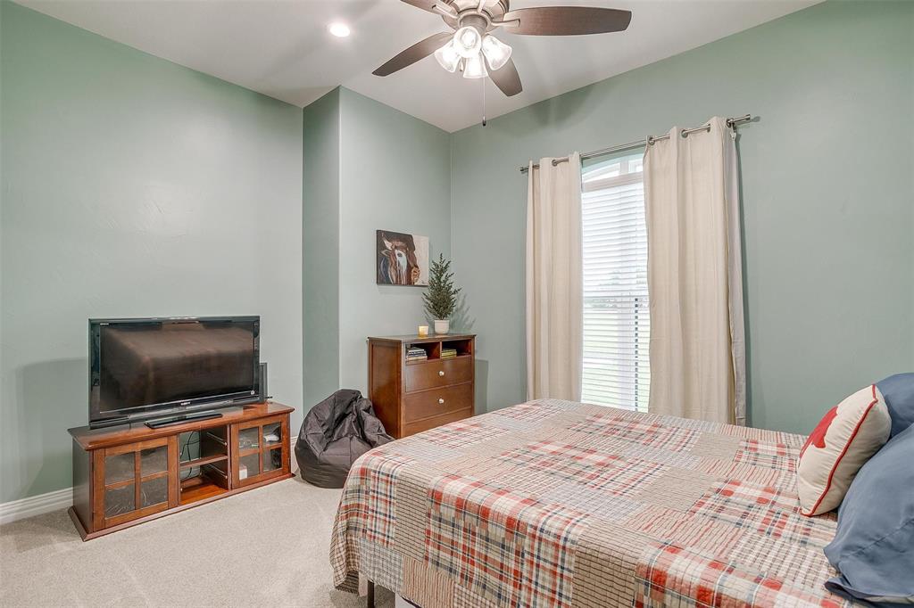 850 McClendon Walker Road Aledo, TX 76008 - Photo 26 of 38 a bedroom with a bed and a flat screen tv