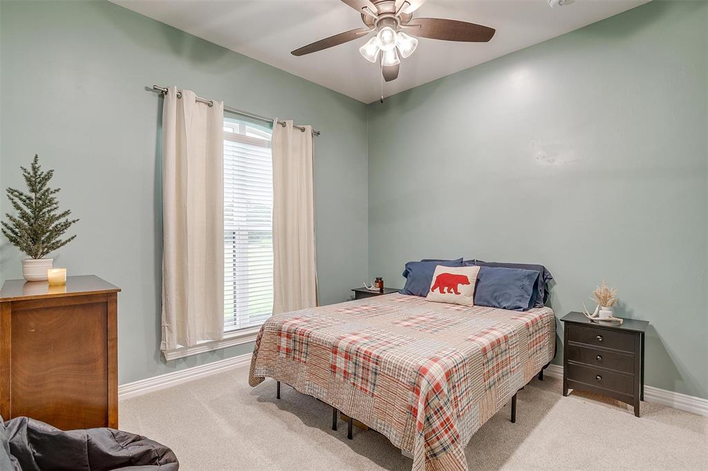 850 McClendon Walker Road Aledo, TX 76008 - Photo 27 of 38 a bedroom with a bed and a chandelier