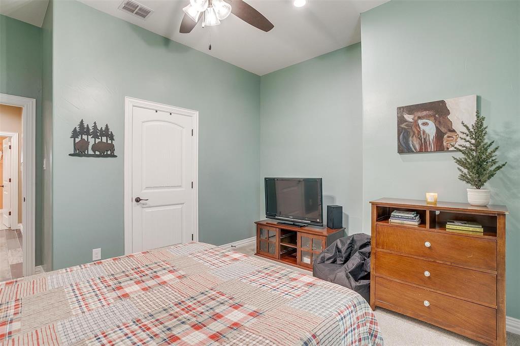 850 McClendon Walker Road Aledo, TX 76008 - Photo 28 of 38 a bedroom with a bed and a television