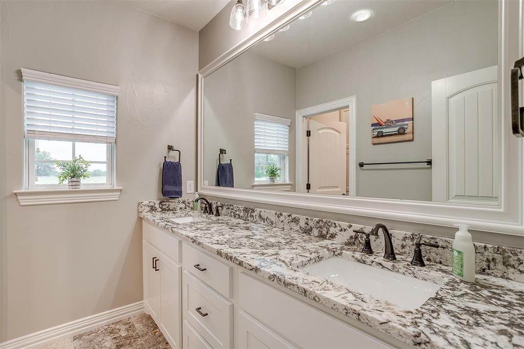 850 McClendon Walker Road Aledo, TX 76008 - Photo 29 of 38 a bathroom with a granite countertop sink and a mirror