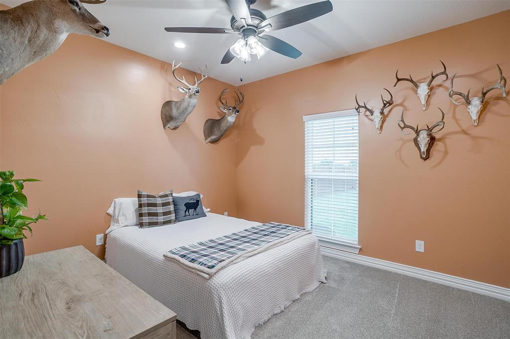 850 McClendon Walker Road Aledo, TX 76008 - Photo 30 of 38 a bedroom with a large bed and a chandelier