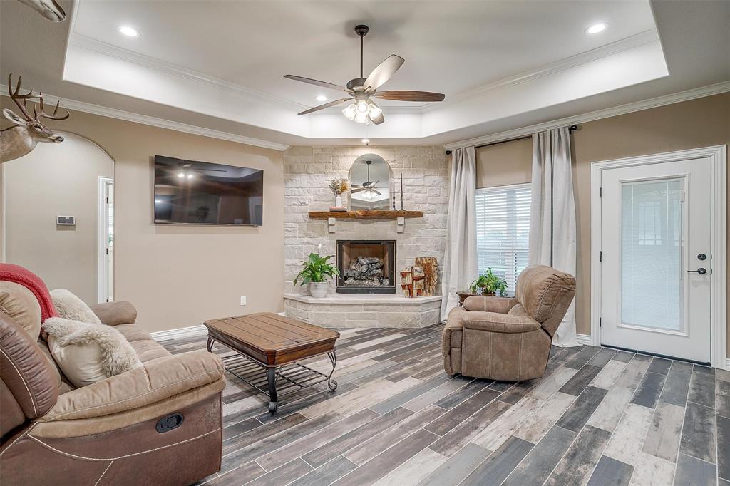 850 McClendon Walker Road Aledo, TX 76008 - Photo 7 of 38 a living room with furniture a fireplace and a flat screen tv