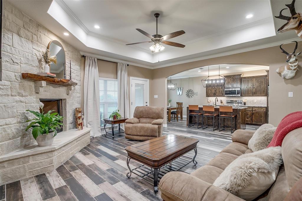 850 McClendon Walker Road Aledo, TX 76008 - Photo 8 of 38 a living room with furniture a fireplace and a chandelier