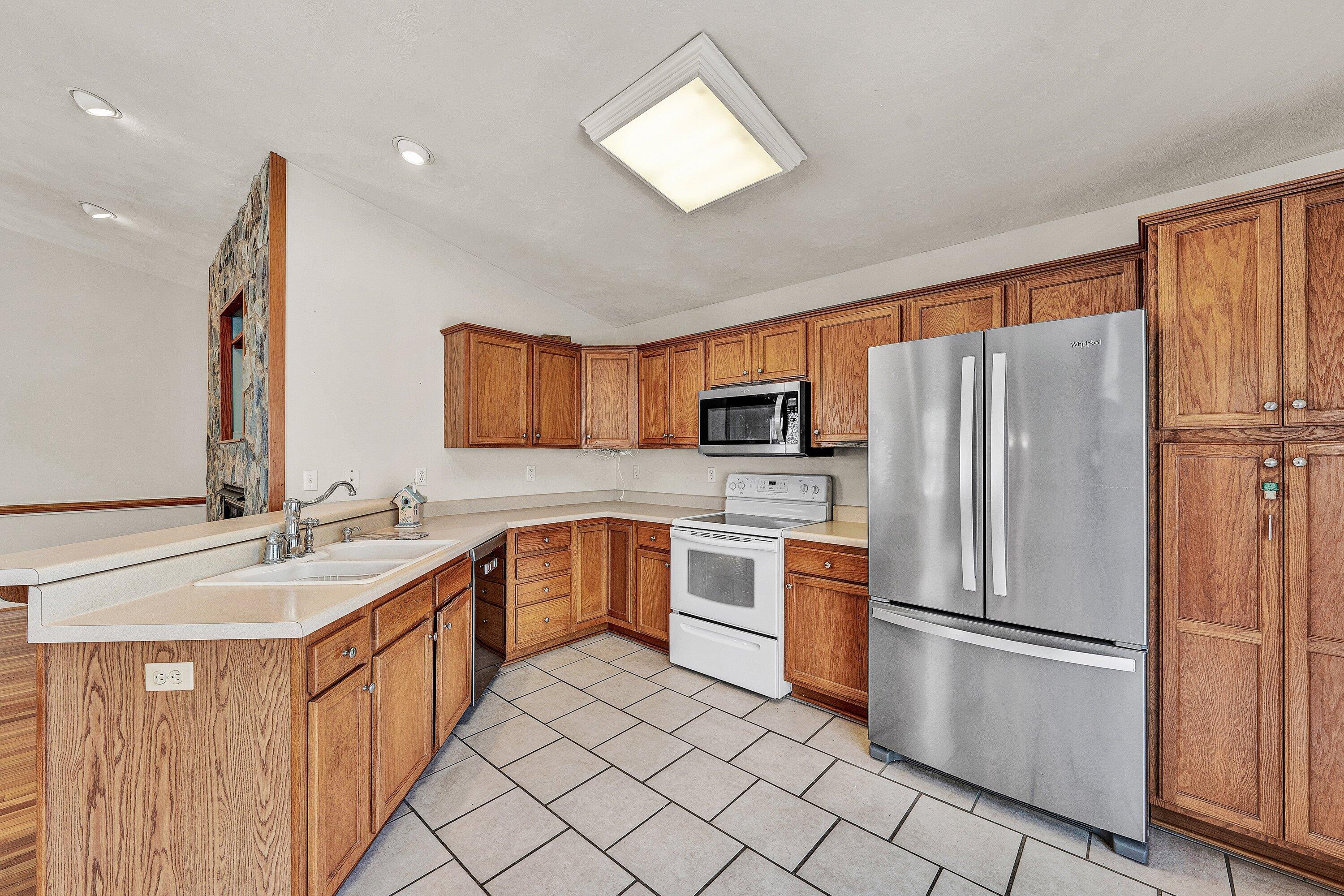 25 Walnut Landing Circle Hardy, VA 24101 - Photo 13 of 56 a kitchen with stainless steel appliances granite countertop a refrigerator sink and stove