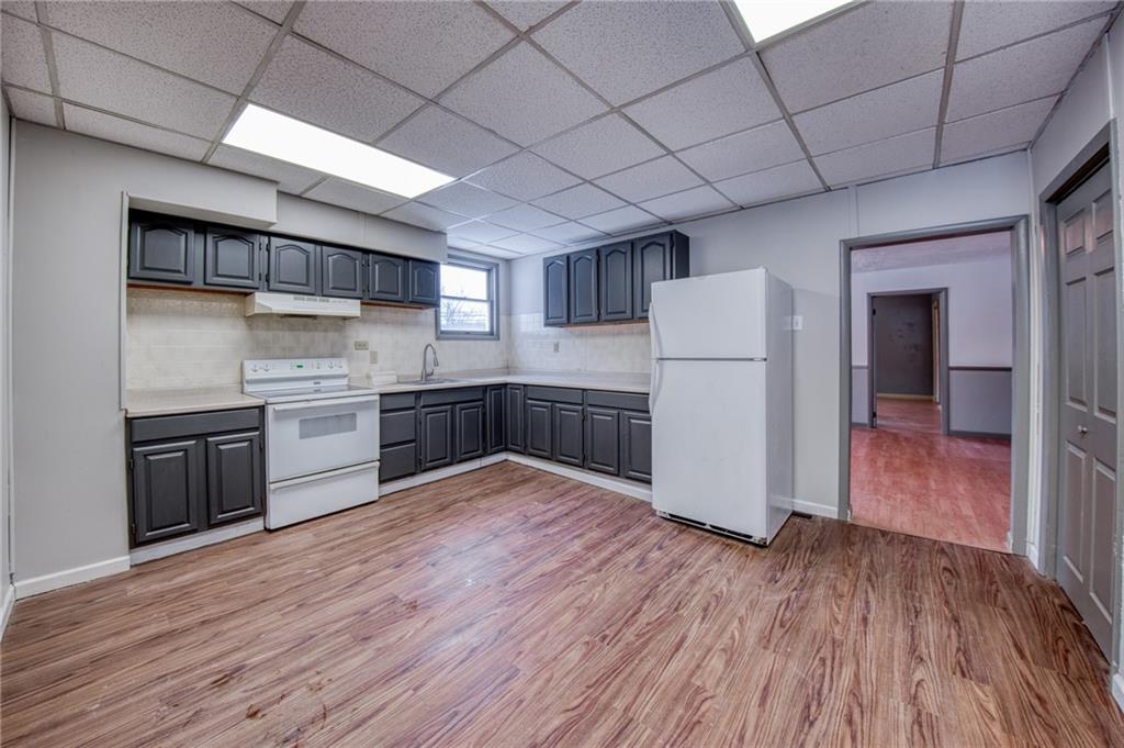 1920 Smith Township State Road Burgettstown, PA 15021 - Photo 13 of 41 a kitchen with stainless steel appliances granite countertop a wooden floors and white cabinets