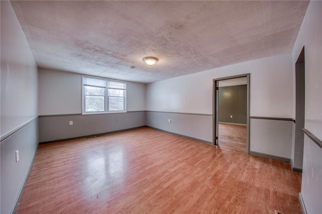 1920 Smith Township State Road Burgettstown, PA 15021 - Photo 16 of 41 an empty room with wooden floor cabinet and windows