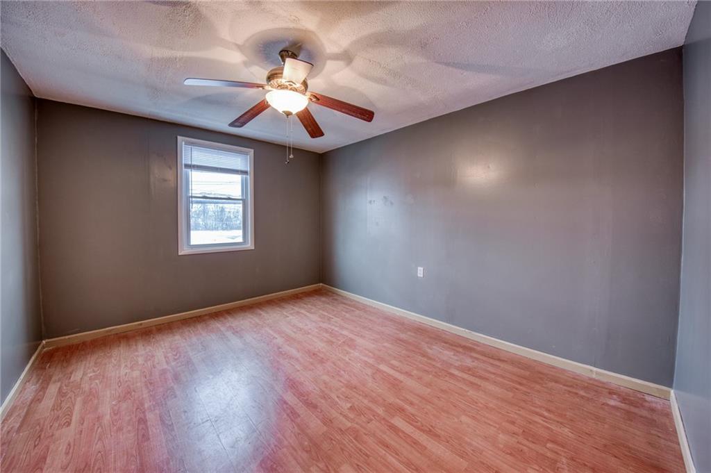 1920 Smith Township State Road Burgettstown, PA 15021 - Photo 24 of 41 an empty room with wooden floor chandelier fan and windows