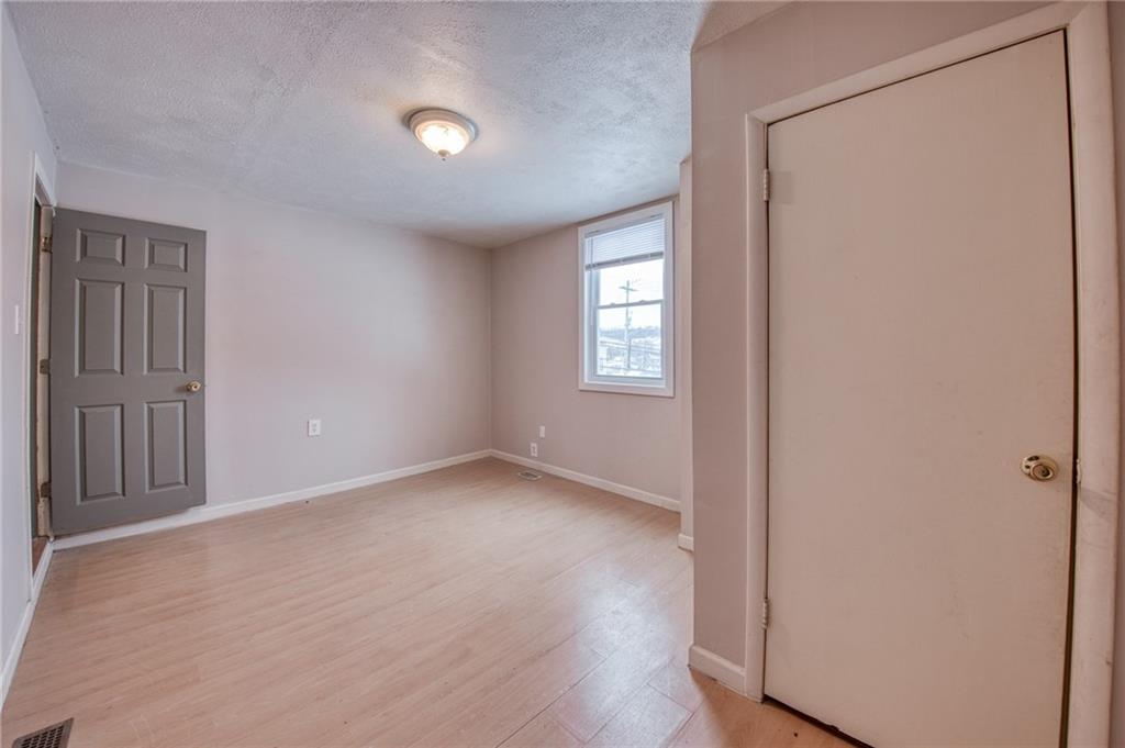 1920 Smith Township State Road Burgettstown, PA 15021 - Photo 29 of 41 an empty room with wooden floor and windows